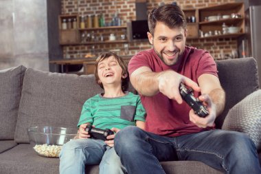 father and son playing video game clipart