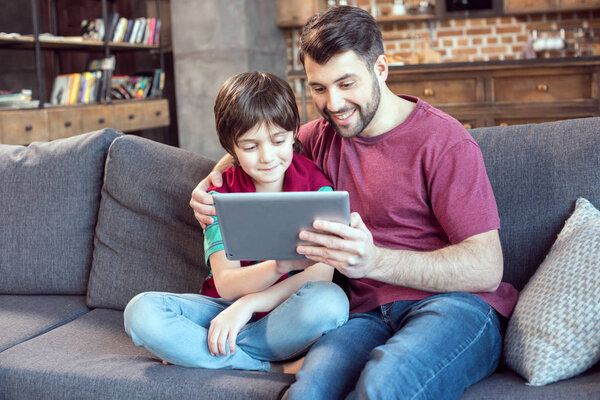 father and son using tablet