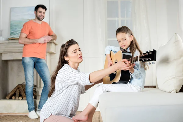 Счастливая семья с гитарой — стоковое фото