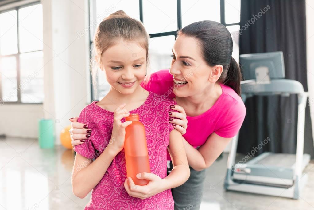 Mother and daughter with sports bottle 