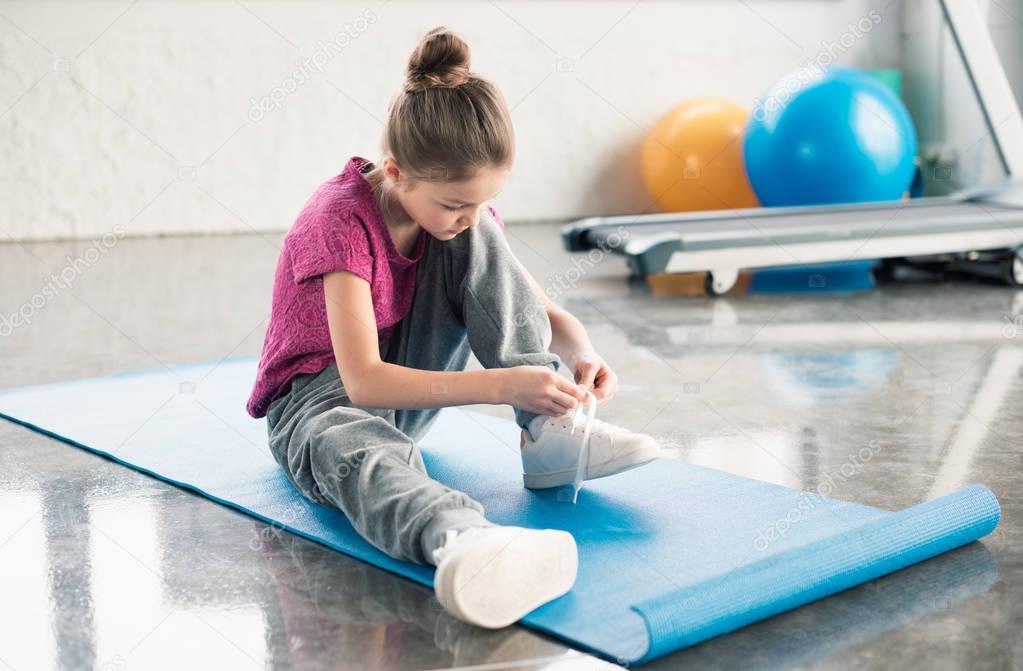 Girl tying shoelace 