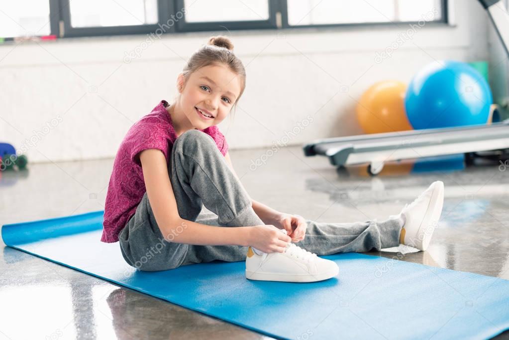 Girl tying shoelace 