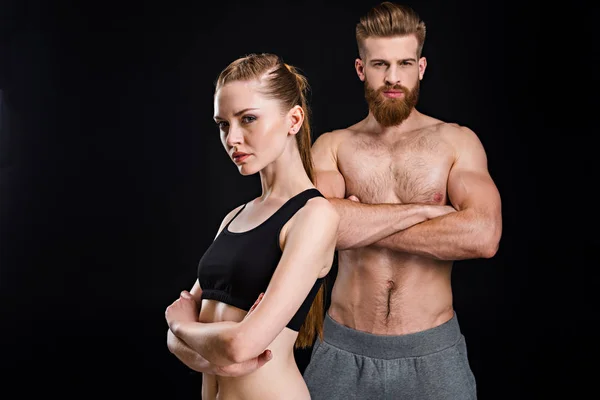 Sportswoman and sportsman posing — Stock Photo, Image