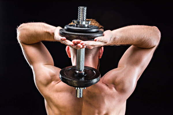 bodybuilder training with dumbbell