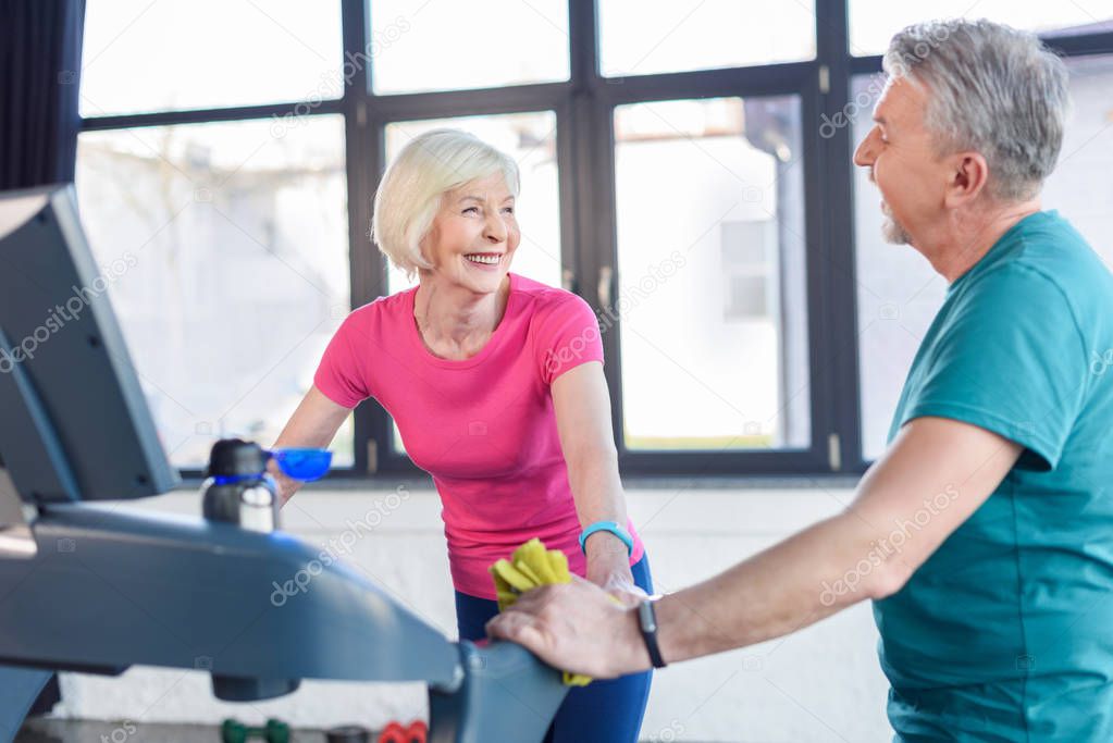 senior couple training on treadmill