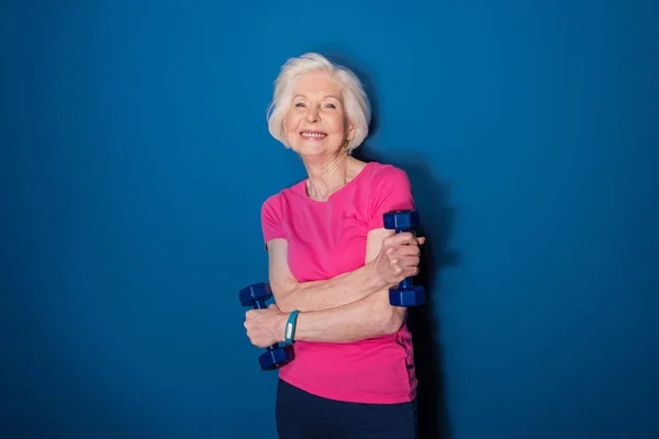 Senior woman with dumbbells — Stock Photo, Image