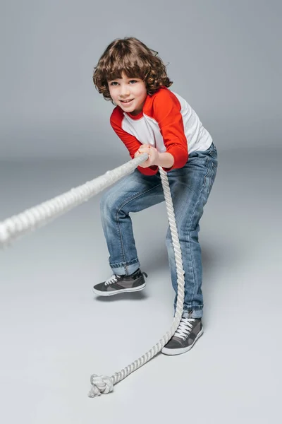 Cute boy play tug of war — Stock Photo, Image