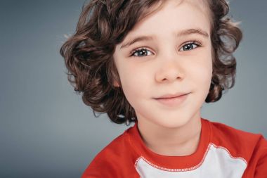 Curly little boy at studio clipart