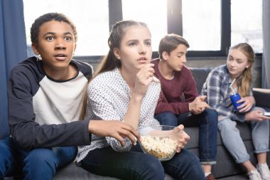Teenagers eating popcorn  clipart