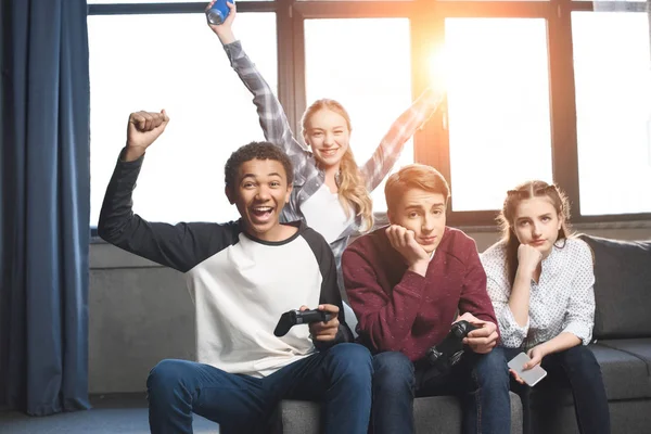 Multicultural teenagers with joysticks — Stock Photo, Image