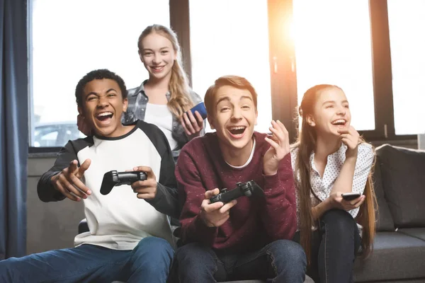 Multicultural teenagers with joysticks — Stock Photo, Image