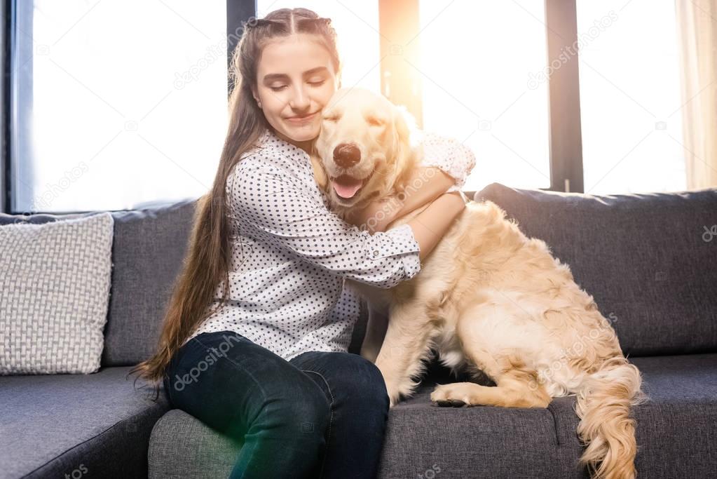 girl hugging dog