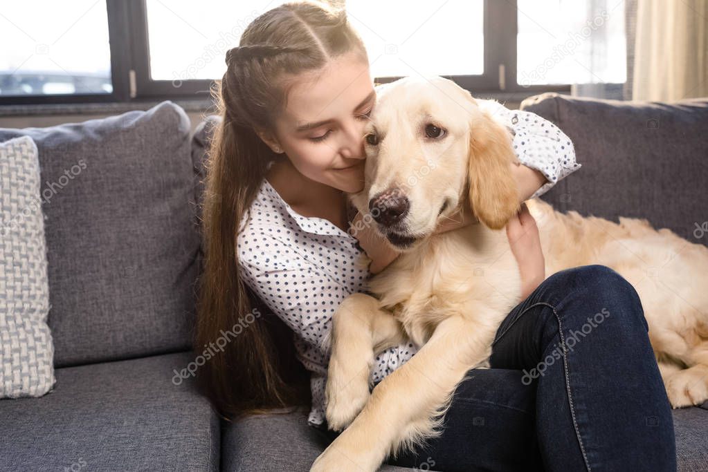 girl hugging dog