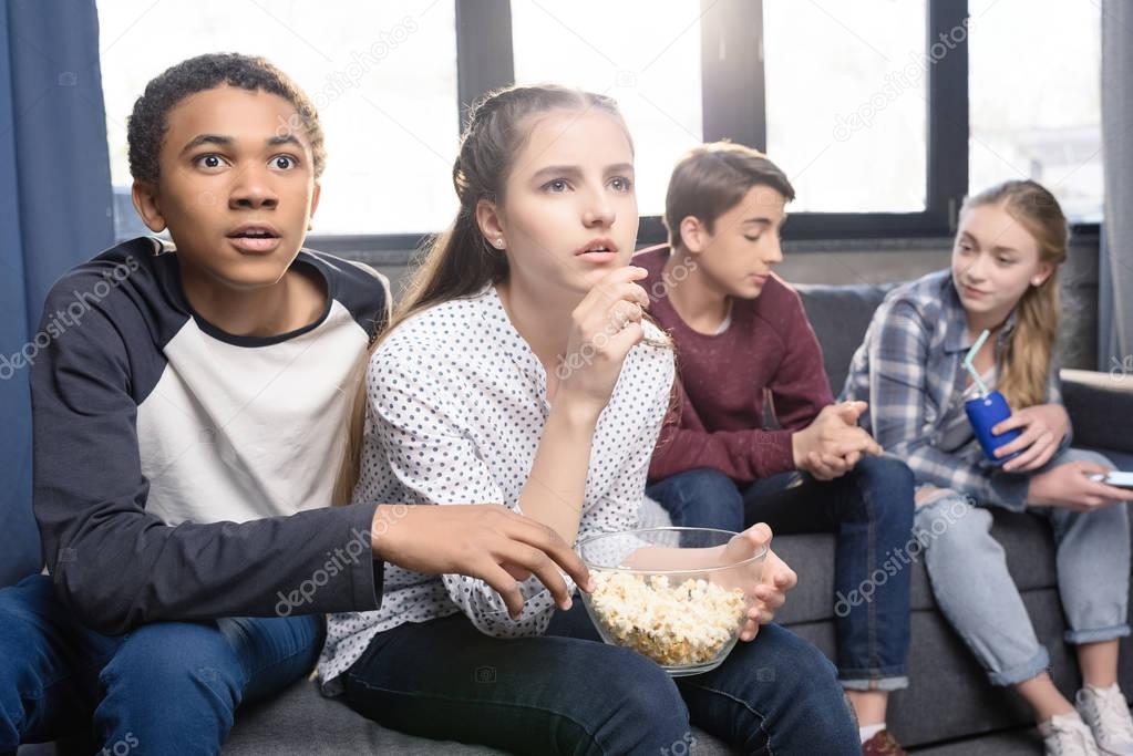 Teenagers eating popcorn 