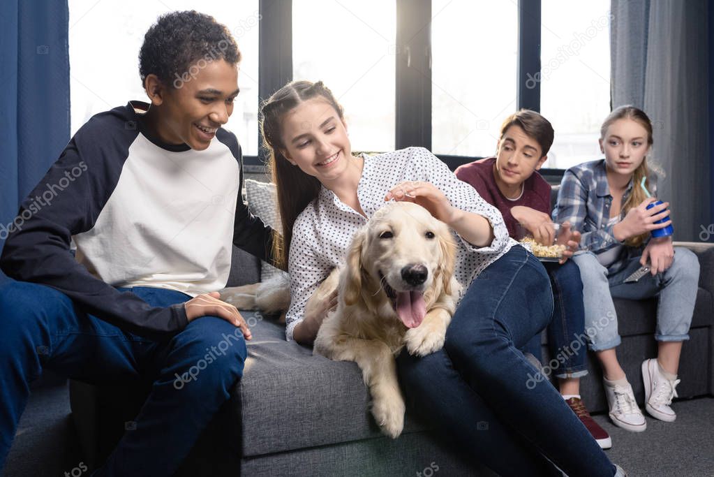 Teenagers with golden retriever dog 