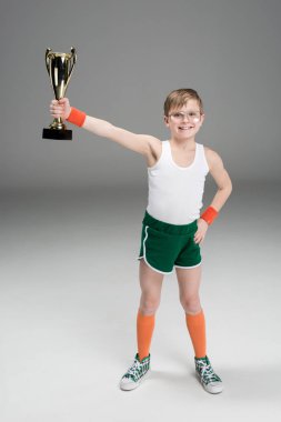 active boy with champion's goblet clipart