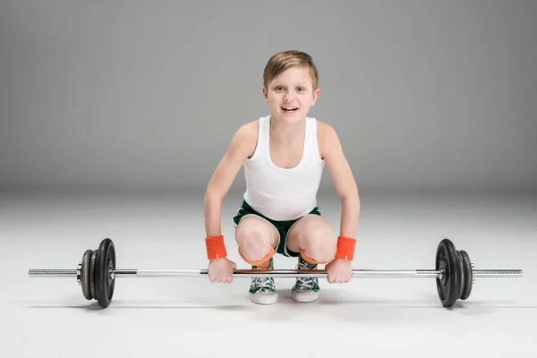 Active boy training with barbell — Stock Photo, Image