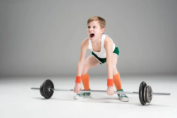 Active boy training with barbell — Stock Photo, Image