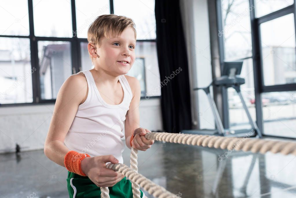 kid boy training with ropes