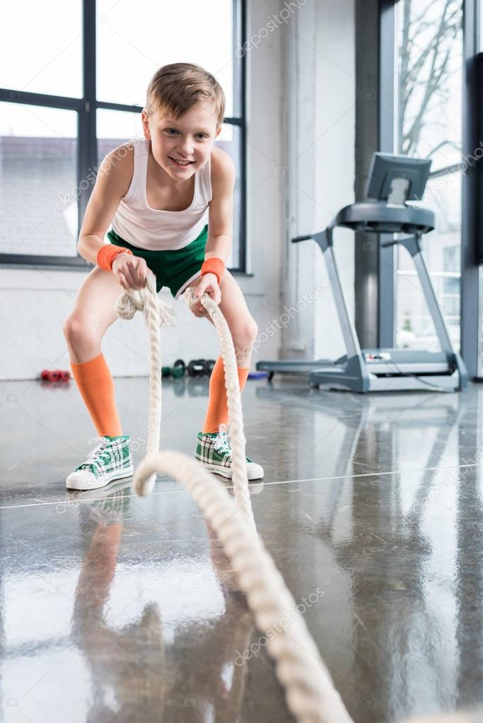 kid boy training with ropes