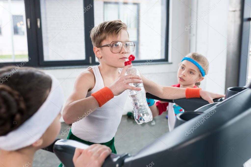 kids in sportswear training on treadmill