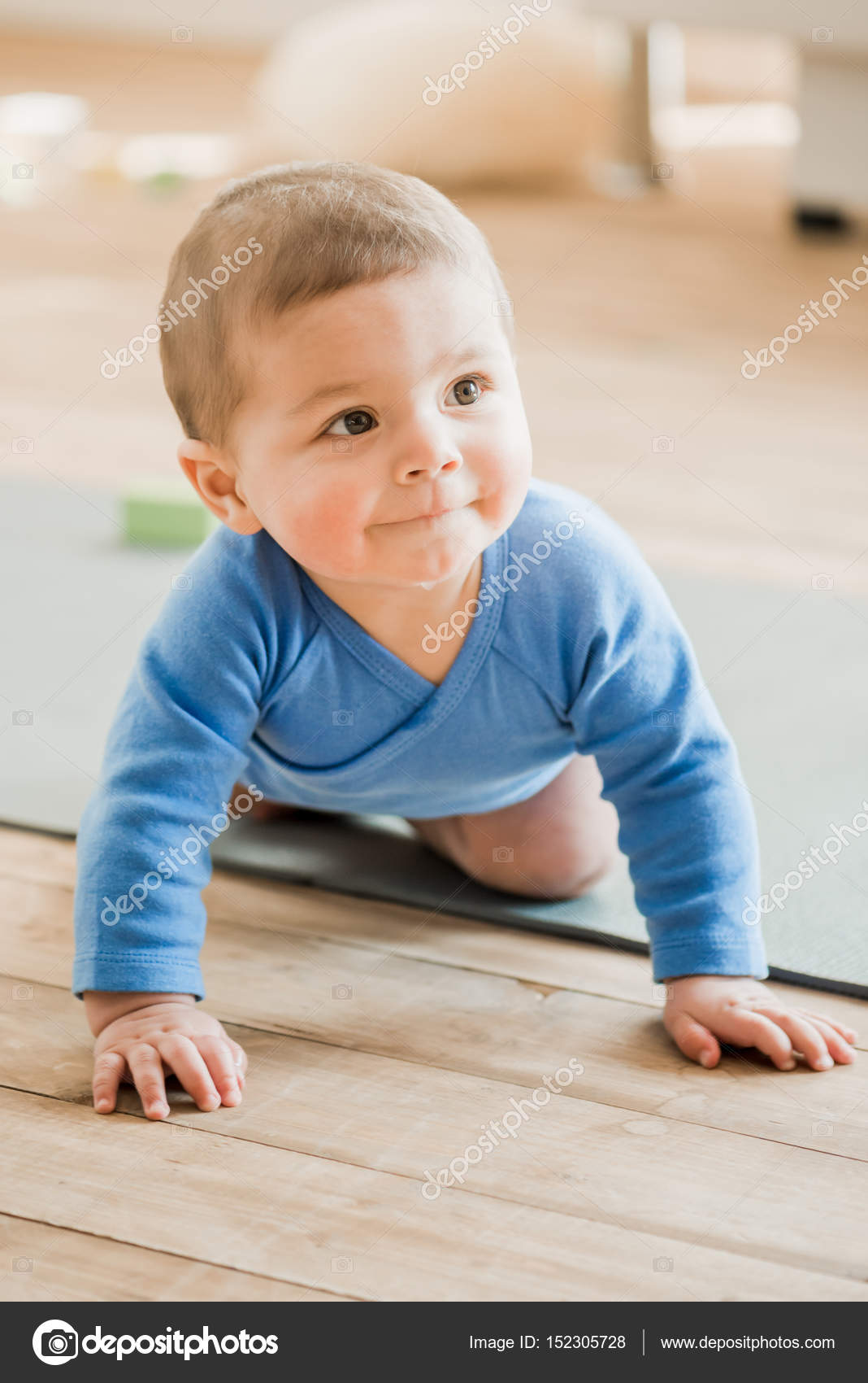 Baby boy crawling on yoga mat Stock Photo by ©NatashaFedorova 152305728
