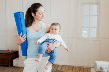 woman carrying baby child on arms clipart