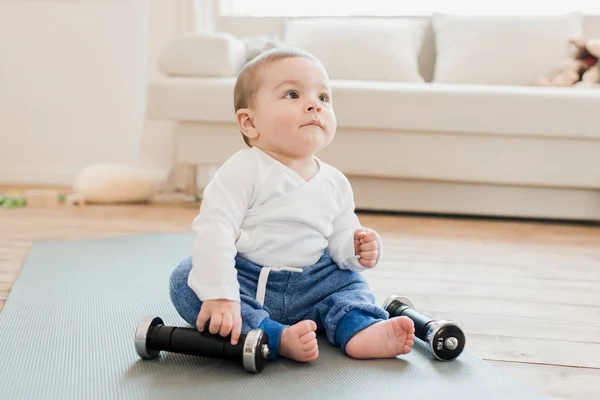 Baby boy playing with dumbbells — Stock Photo, Image