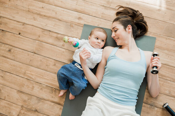 mother and baby boy playing with dumbbells
