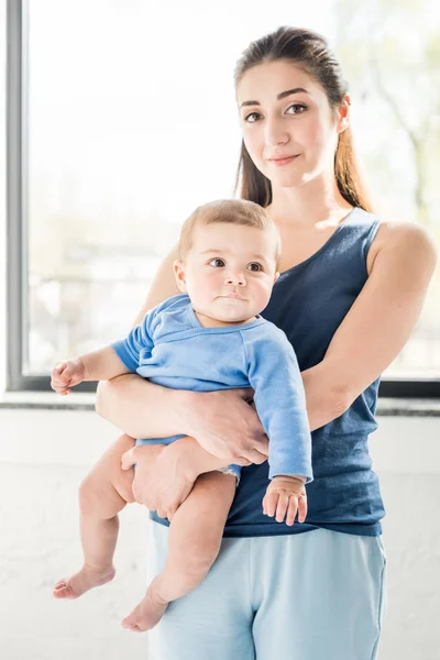 Young mother holding her baby son — Stock Photo, Image