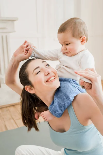 Mother carrying her son piggyback Stock Image