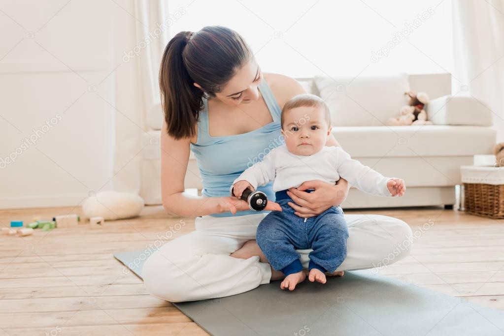 Woman with baby child playing together