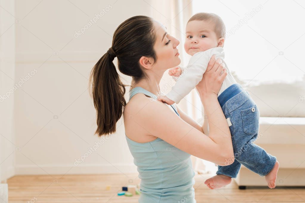 Young mother playing with her son 