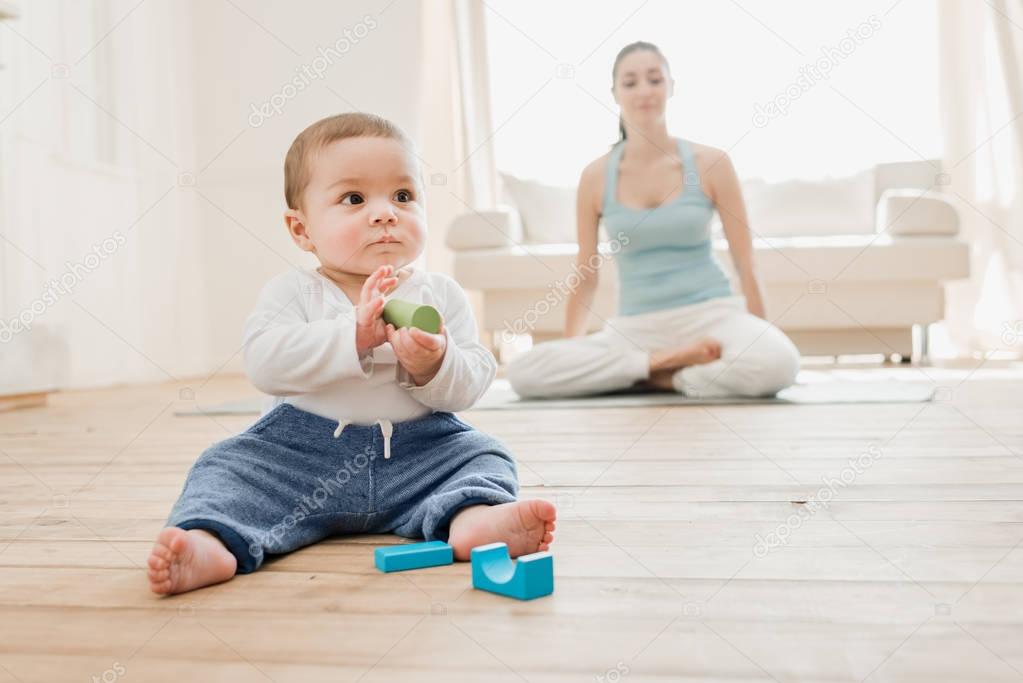 Baby boy with his mother at home