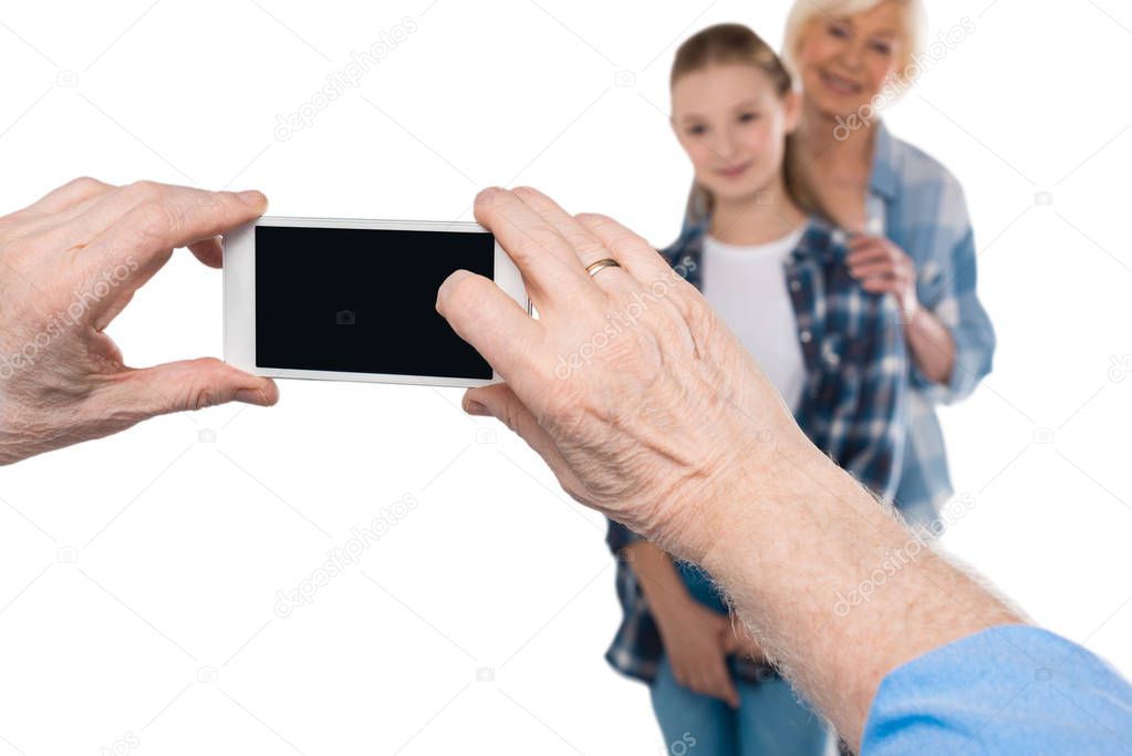 Grandfather taking photo on smartphone