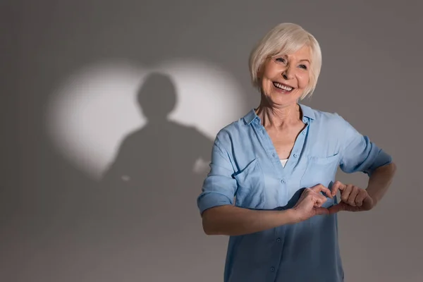 Woman with heart shaped shadow — Stock Photo, Image