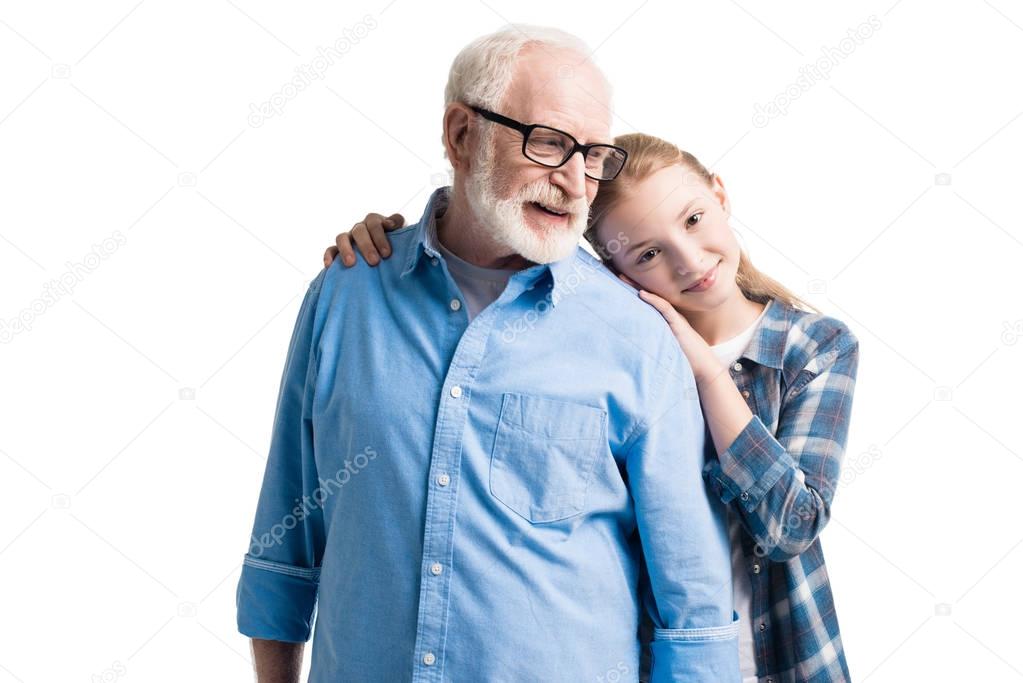 grandfather and granddaughter hugging