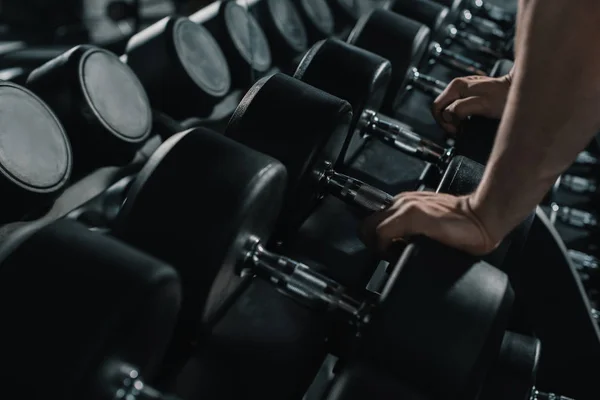 Sportsman taking big dumbbell — Stock Photo, Image