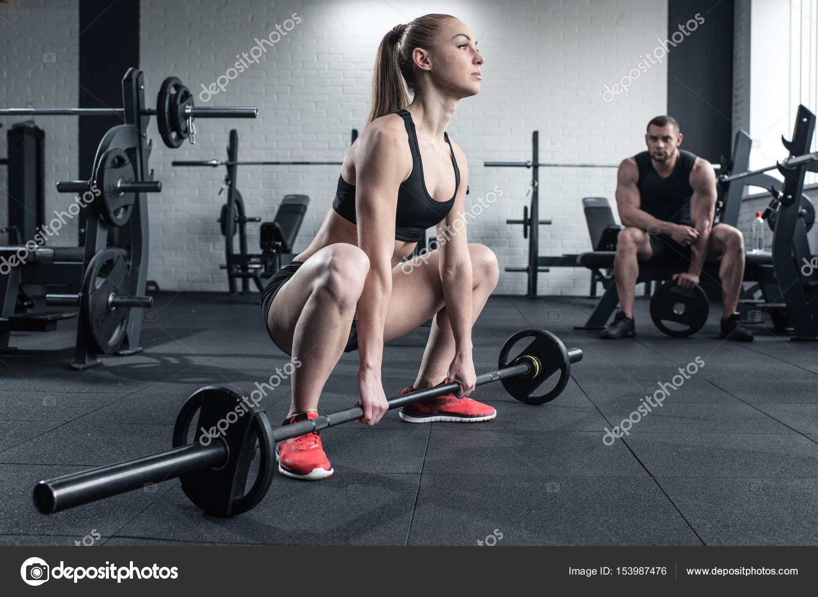 Woman doing strength training while man sitting — Stock Photo