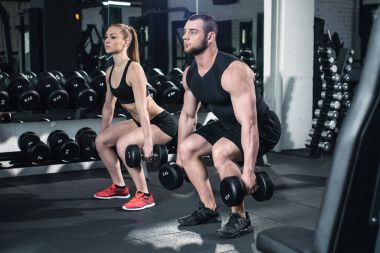 couple exercising with dumbbells  clipart