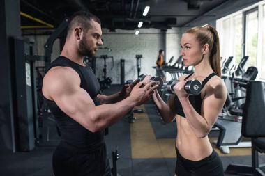 young couple of athletes training at gym clipart
