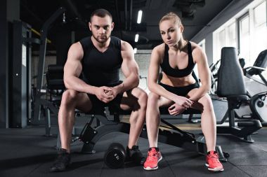 young couple of athletes training at gym clipart