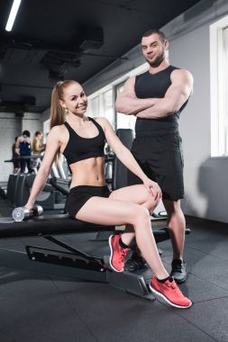 young sporty caucasian couple at gym clipart