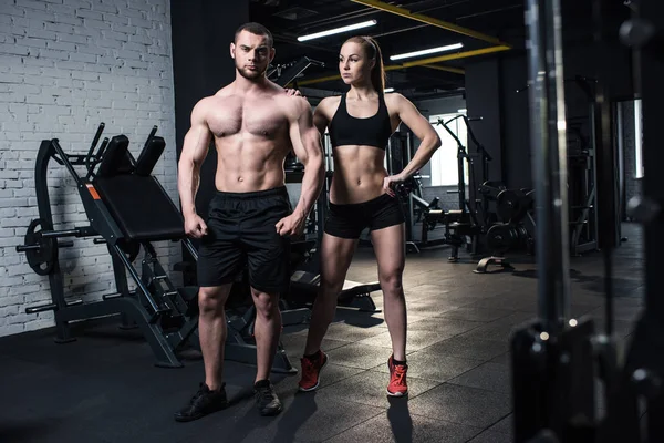 Pareja deportiva posando en el gimnasio — Foto de Stock