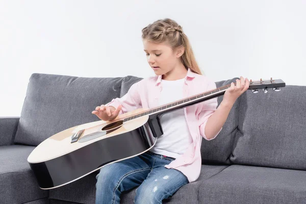 Girl practicing to play on guitar — Free Stock Photo