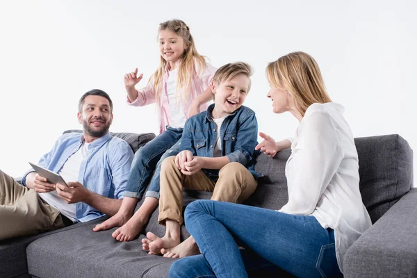 Caucasian family sitting on sofa together — Stock Photo, Image