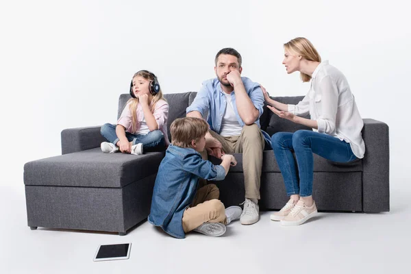 Caucasian family sitting on sofa together — Stock Photo, Image