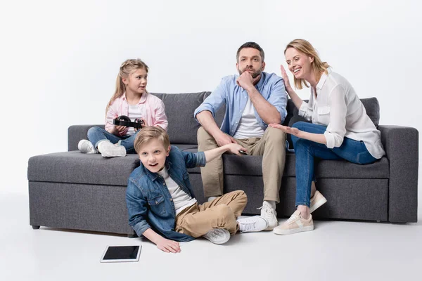 Caucasian family sitting on sofa together — Stock Photo, Image