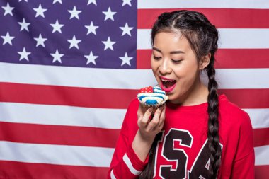 woman with cupcake decorated with American flag clipart