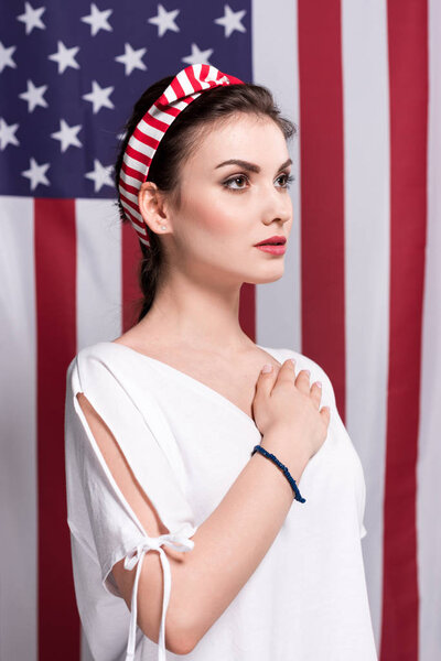 pensive woman with hand on chest